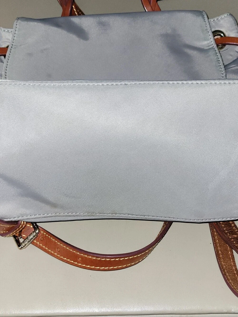 Dooney & Bourke Light Gray Nylon Backpack with Brown Leather Trim.